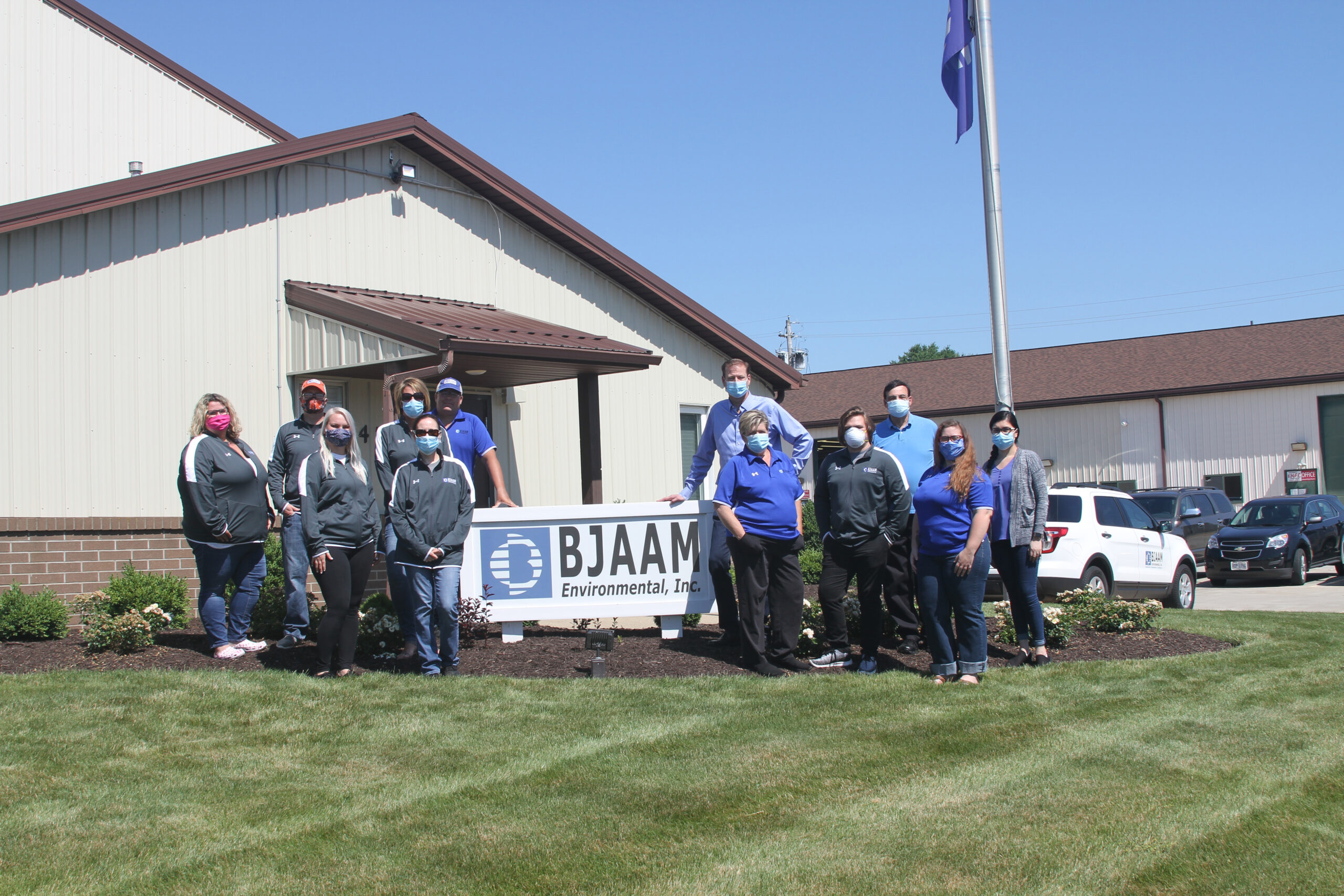 BJAAM Finance Team standing outside the corporate headquarters