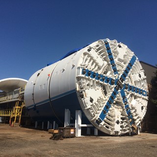 Extremely large white and blue drill bit on a cloudless day
